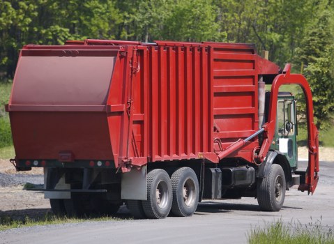 Low-emission van unloading recyclables at a transfer station